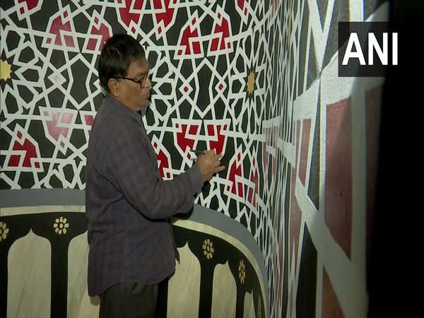 Anil Kumar Chawhan painting the walls of a mosque in Hyderabad. (Photo/ANI)