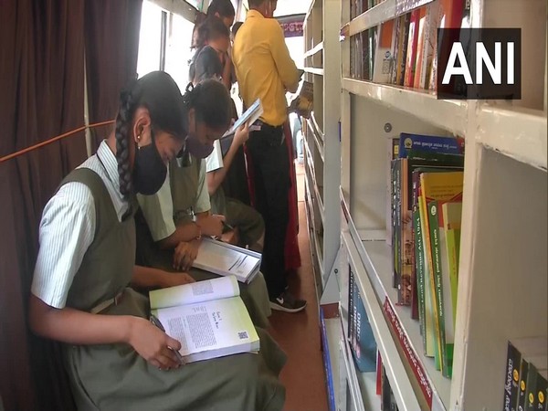 Children reading books in the mobile library. (Photo/ANI)