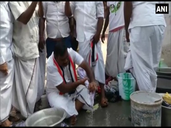 AIADMK candidate Thanga Kathiravan washing people's clothes in Tamil Nadu on Monday.