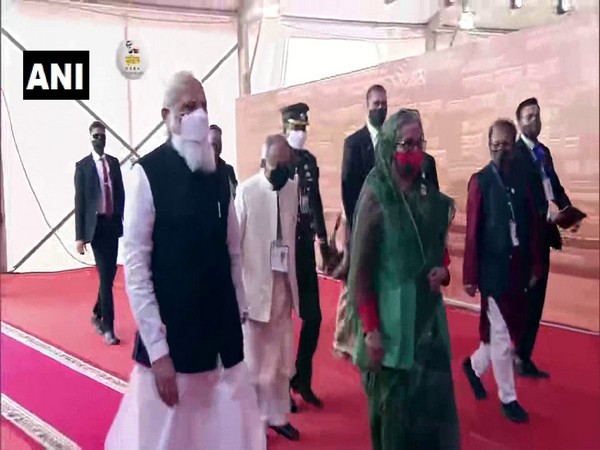 PM Narendra Modi, with his Bangladesh counterpart Sheikh Hasina, arrives at National Parade Ground in Dhaka to take in National Day programme.