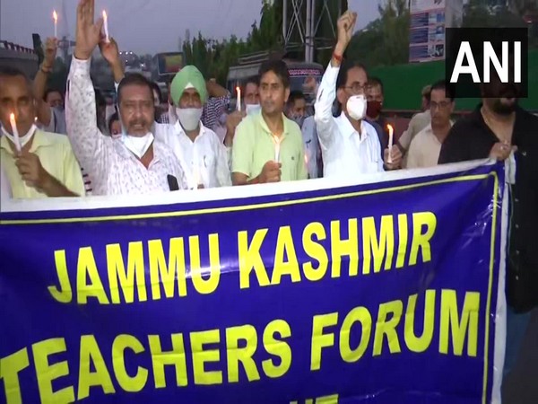 Jammu and Kashmir Teachers forum holding a candle march protest against the selective killing in the valley. (Photo/ANI)
