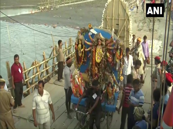 Devotees carry an idol of Goddess Durga for immersion in Guwahati on Friday. [Photo/ANI]