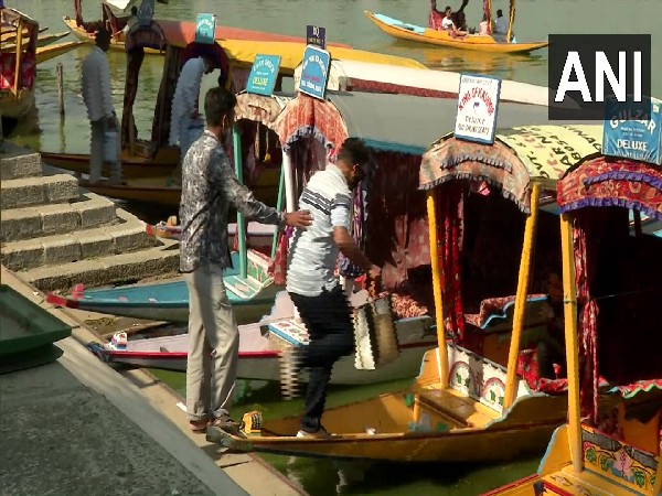 Tourists heading to experience Dal lake ride on boat (Photo/ANI)