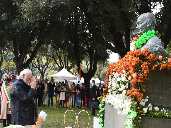 PM Modi paying tribute to Mahatma Gandhi's bust at Piazza Gandhi in Rome.