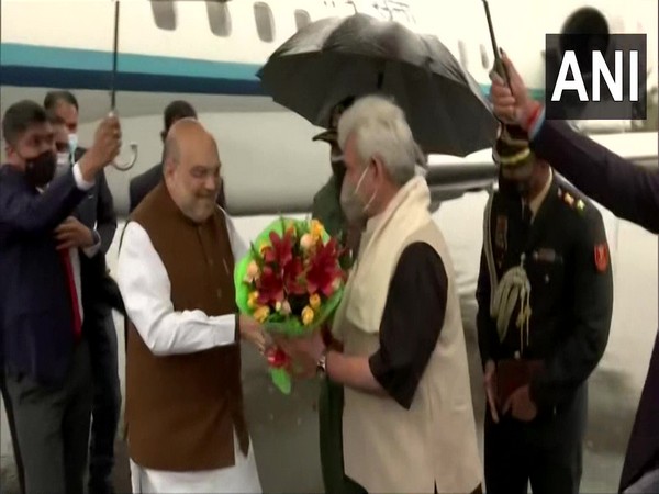 Union Home Minister Amit Shah welcomed in Srinagar by J-K LG Manoj Sinha. (Photo/ANI)
