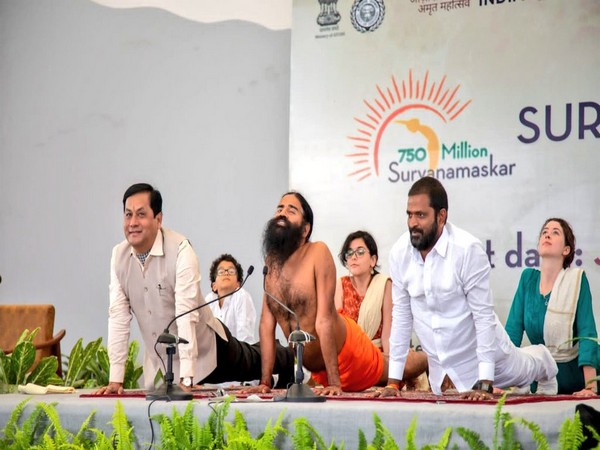 Union Minister Sarbananda Sonowal performing Surya Namaskar with Swami Ramdev