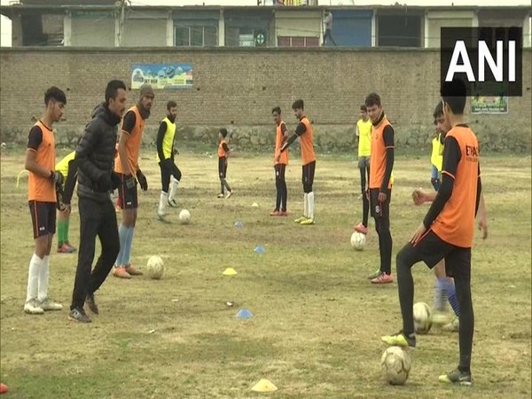 Children continue football training despite harsh winter conditions in Pulwama (Photo/ANI)