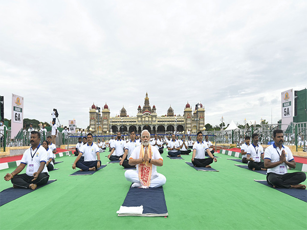 Prime Minister Narendra Modi performing yoga at Mysore Palace grounds