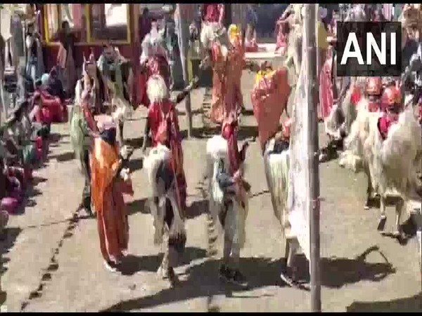 Men dressed in traditional attire with masks on their faces were seen dancing in circles and moving in subtle steps as others play instruments. Photo/ANI
