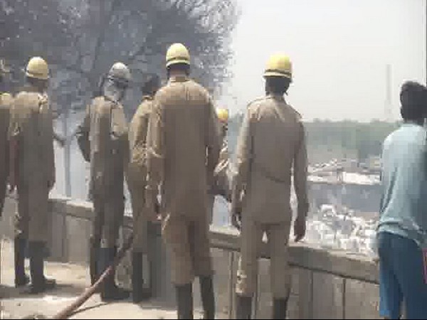 Firefighters dousing fire at the Geeta colony slum in East Delhi on Saturday (Photo/ANI)
