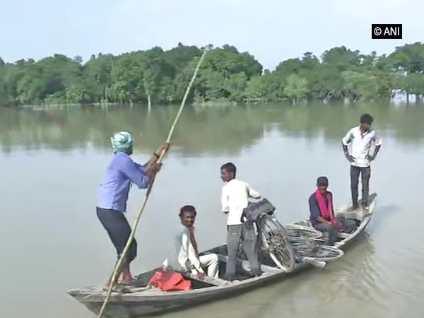 Villagers using boat to travel during flood in Darbhanga, Bihar on July 18. Photo/ANI
