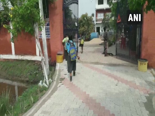 The students disposing waste materials that they have collected while their way to school in Gaya. Photo/ANI