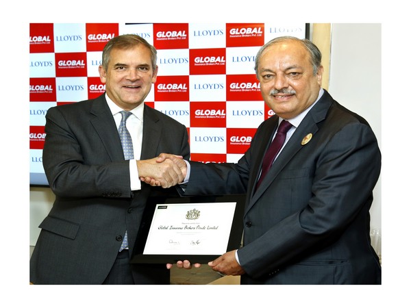 Bruce Carnegie-Brown (left) handing over the certificate of accreditation to Prabodh Thakker