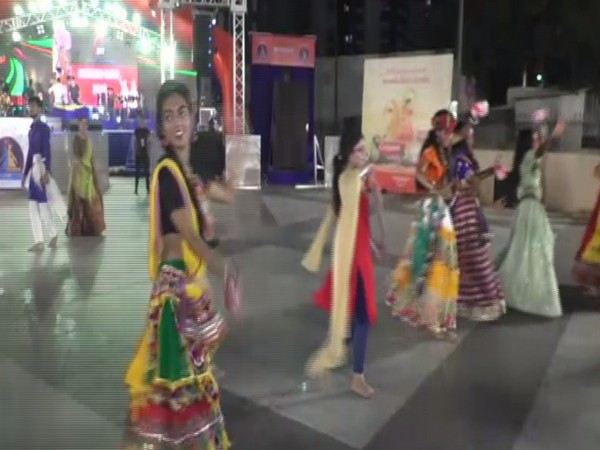 Students and teachers of Institute of Design and Technology perform 'Garba' holding sanitary napkins in their hands. Photo/ANI