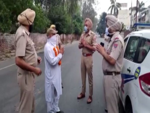 Punjab Police request a man to stay indoors during lockdown on Saturday. Photo/ANI