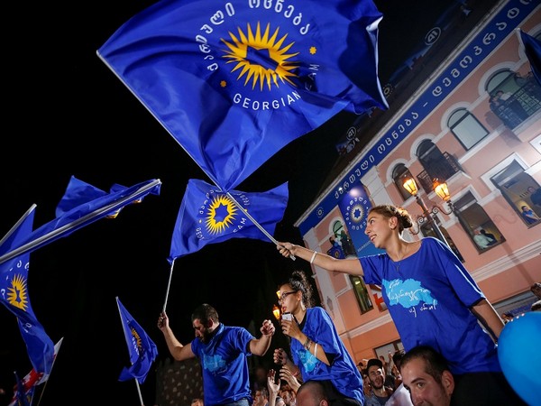 Georgian Dream party supporters waiving flag after parliamentary election result (Photo Credit: Reuters)