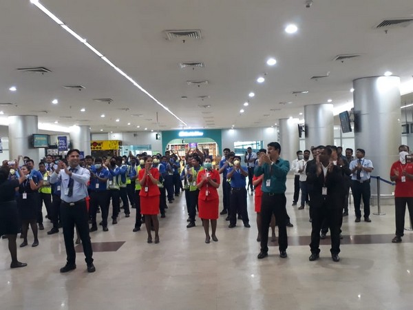 Airport staff clapping for essential service providers. Photo/ANI