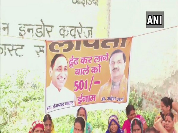 esidents of Surajpur in Greater Noida protest with a missing poster of MP Mahesh Sharma & MLA Tejpal Singh Naga