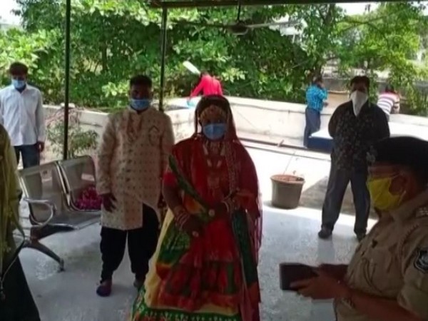 The bride and groom along with their family members at a temple in Navsari. Photo/ANI
