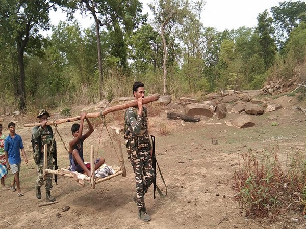 CRPF personnel carrying the ailing boy on a cot on Thursday. (Photo: ANI)