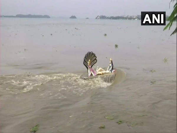 Visuals of water touching the feet of the statue of Lord Vishnu on the vertical pillar in the river near Chakreshwar Temple in Kalipur on Saturday. Photo/ANI