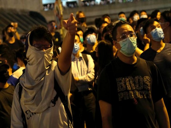 Protesters shouting slogans while clashing with police forces in Hong Kong on Tuesday night.