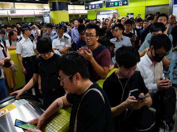 Anti-government demonstrators block metro services in Hong Kong on Tuesday.