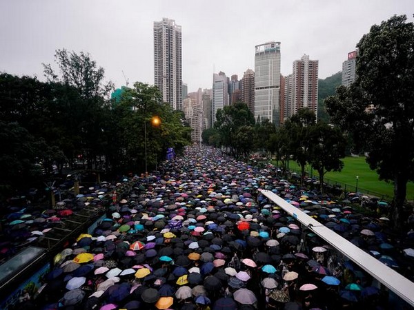 Thousands of anti-government protesters braved torrential rains on Sunday as they marched along the main thoroughfares of Hong Kong Island