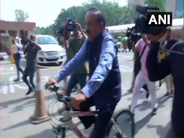 Union Minister Dr Harsh Vardhan rides a bicycle to take charge of Ministry of Health and Family Welfare in New Delhi on Monday.