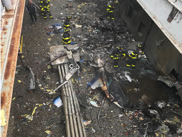 The remains of the Agusta A109E helicopter on the roof of midtown Manhattan building in New York on Monday. (Picture Credits: NYC Fire Department)