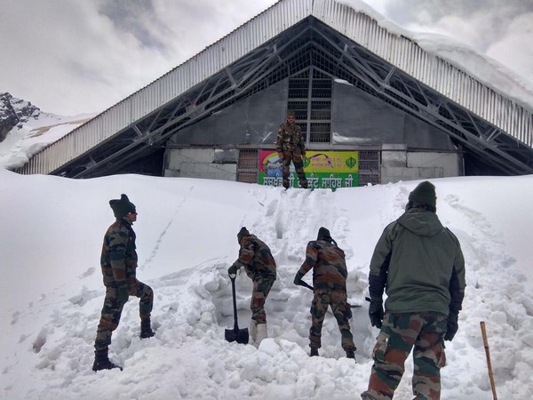 Army men clearing the snow surrounding Hemkund Sahib Gurudwara last week.