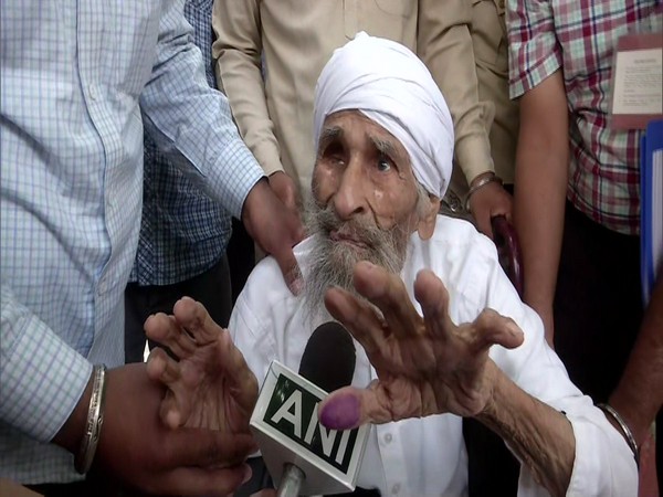 Delhi's oldest voter, 111-year old Bachan Singh after casting his vote at a polling booth in Sant Garh. (Photo/ANI)