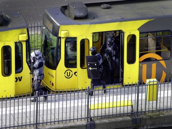Police search a tram after a gunman opened fire in Utrecht on Monday.