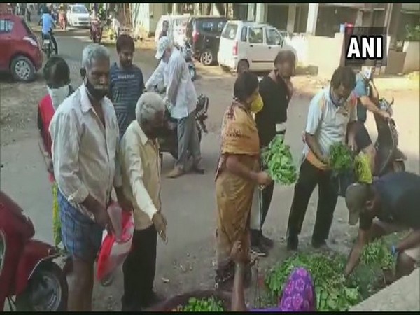 People flout social distancing norms at a vegetable shop in Hubli