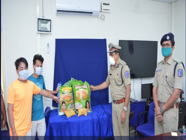 Rachakonda Police Commissioner, Mahesh M Bhagwat handing rice and pulses to Manipuri students. (Photo credi- Twitter/Rachakonda Police)
