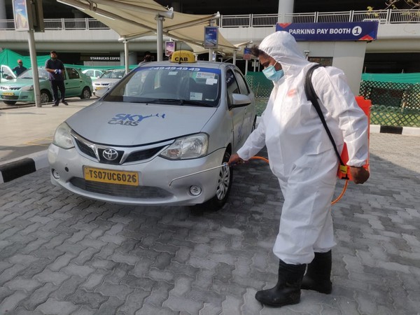 Designated taxi sanitisation personnel sanitising the taxi at Hyderabad Airport on Monday. Photo/ANI