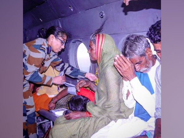 People rescued by IAF onboard helicopter. (Photo/ANI)