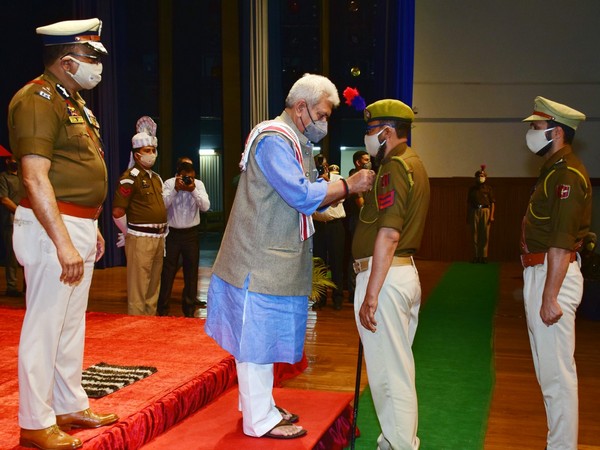 Jammu and Kashmir LG Manoj Sinha awarding a Police officer with the President's Police Medal.