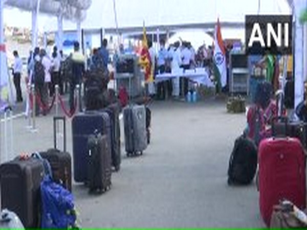 Indian nationals wait to board INS Jalashwa at Colombo on Monday.