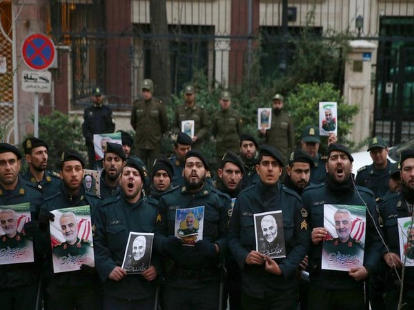Iranian policemen hold pictures of the late Iranian Major-General Qassem Soleimani, during a protest against the assassination of Soleimani, who was killed in an airstrike at Baghdad airport.