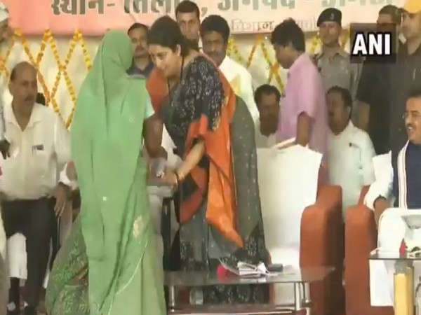 Union Minister Smriti Irani consoling a woman who fell down at her feet in Amethi on Saturday.