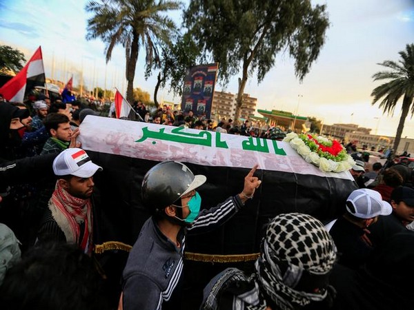 Mourners carry a mock coffin for an Iraqi demonstrator, who was killed on Tuesday during ongoing anti-government protests in Baghdad, Iraq