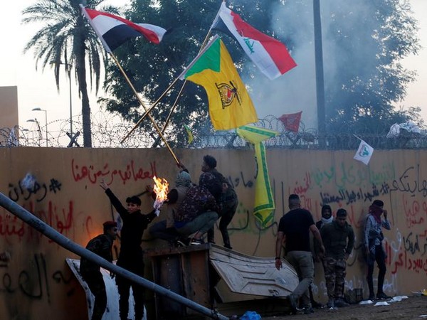 Protesters gather to condemn airstrikes on bases belonging to Hashd al-Shaabi (paramilitary forces), outside US Embassy in Baghdad, Iraq December 31, 2019.