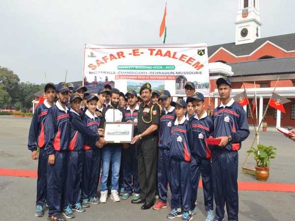 Lietenant General SK Jha with the school children from Baramulla at the IMA in Dehradun on Thursday. Photo/ANI