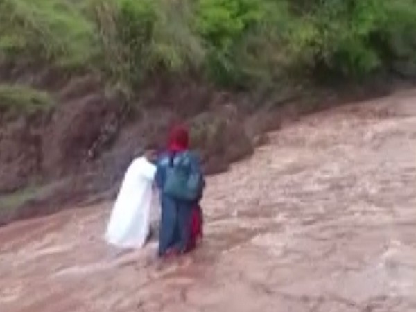 The team of health workers crossing the river.