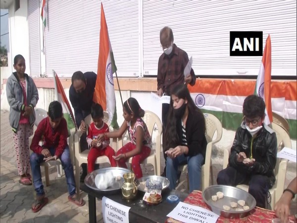 Children making earthen lamps in Jammu on Thursday. (Photo/ANI)