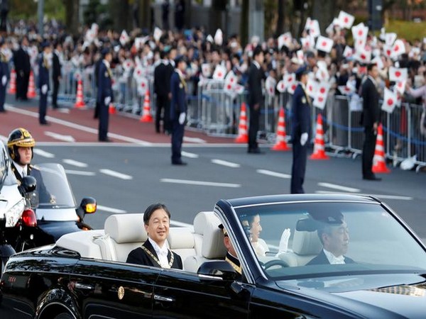    Japan's Emperor Naruhito and Empress Masako ride in a car during their royal parade to mark the enthronement of new Japanese Emperor in Tokyo on Sunday