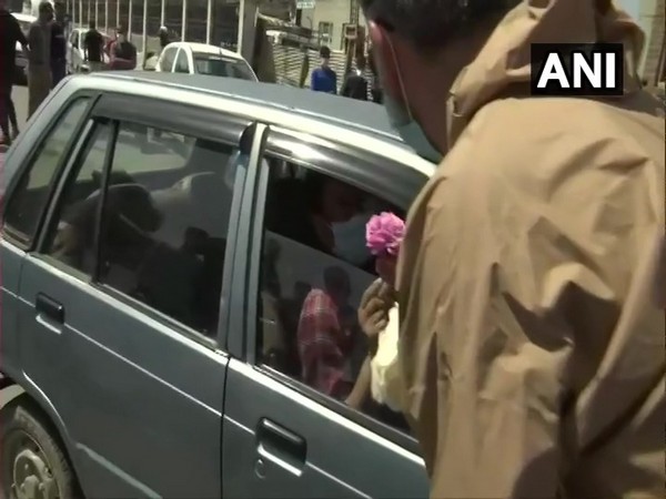 A visual of Jammu and Kashmir police giving flower to a doctor. (Photo/ANI)