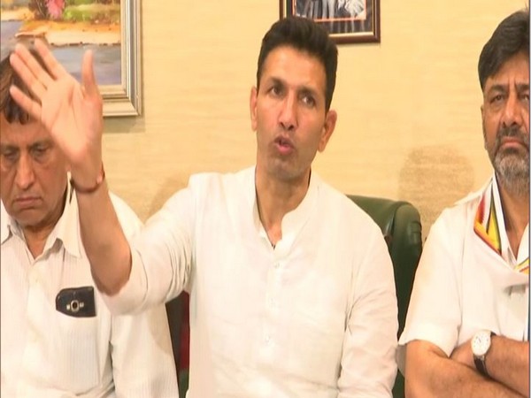 Congress leaders Jitu Patwari and DK Shivakumar with the father of MLA Manoj Choudhary speaking to reporters on Thursday. Photo/ANI