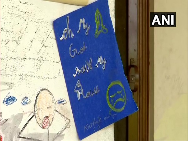 Painting outside a vacated house in Kochi's Maradu. Photo/ANI